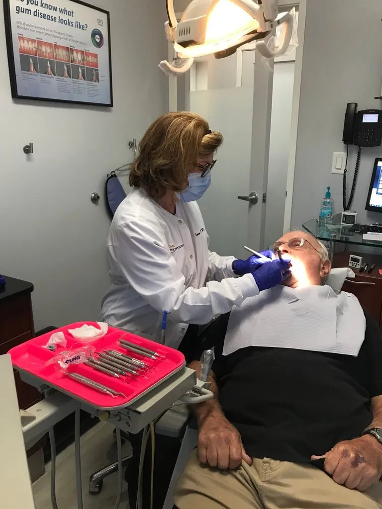 dental hygienist cleaning a patient's teeth at Beverly Hills Aesthetic Dentistry