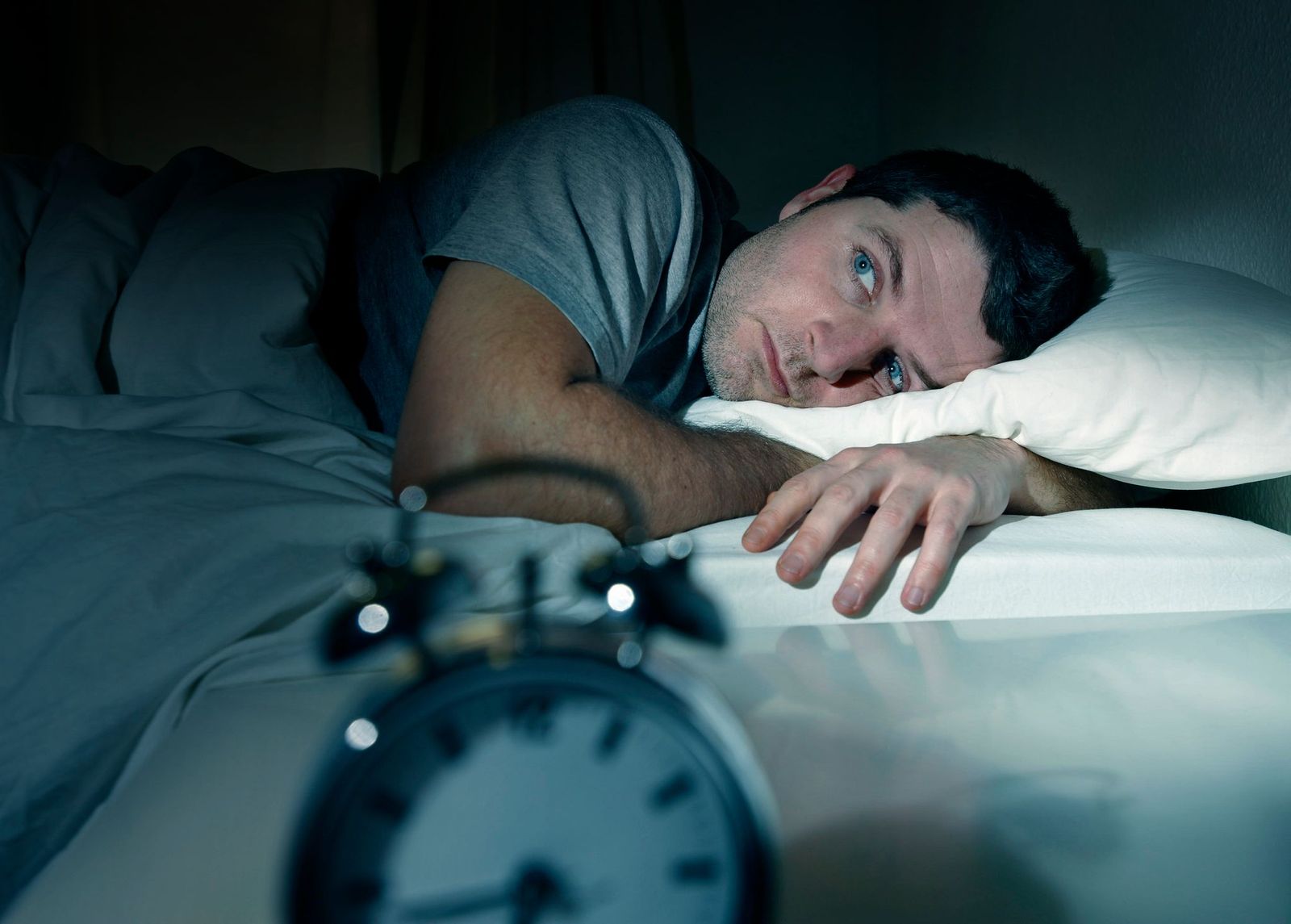 man awake in the middle of the night from sleep apnea
